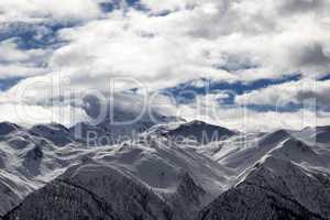 View on snowy mountains and cloudy sky at evening