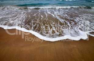 Sea beach with waves in dull day