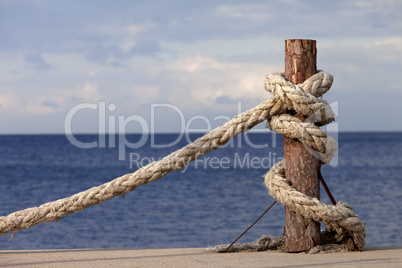 Rope on seafront and cloudy sky in autumn