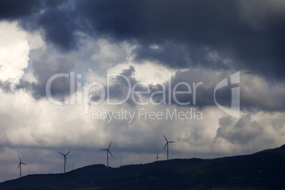 Wind farm and cloudy sky before storm