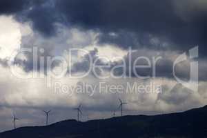 Wind farm and cloudy sky before storm