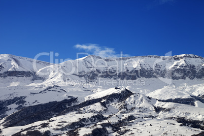 Snowy mountains and blue sky at nice sun day