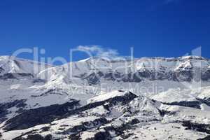 Snowy mountains and blue sky at nice sun day
