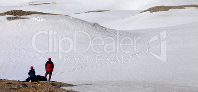 Two hikers on halt in snowy mountain