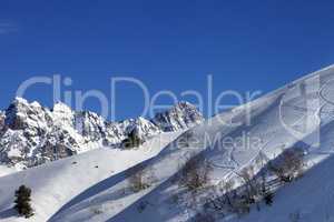 Off-piste slope with track from ski and snowboard on sunny morni