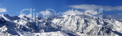 Panoramic view on snowy mountains in nice sunny day