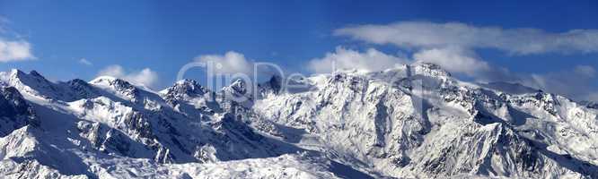 Panoramic view on snowy mountains in nice sunny day