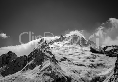 Black and white Caucasus Mountains in cloud