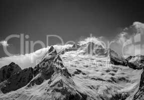 Black and white Caucasus Mountains in cloud