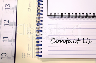 Contact us write on notebook