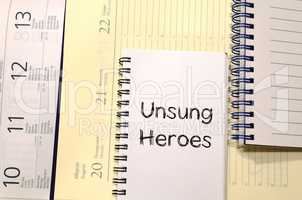 Unsung heroes write on notebook