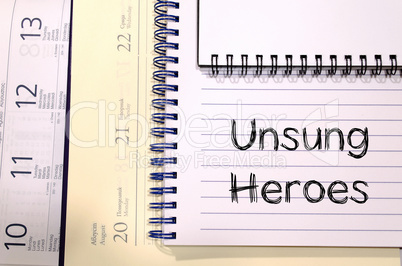 Unsung heroes write on notebook