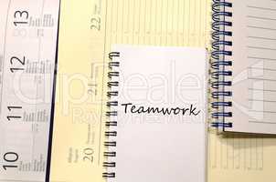 Teamwork write on notebook