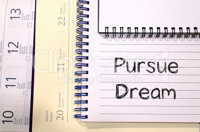 Pursue dream write on notebook
