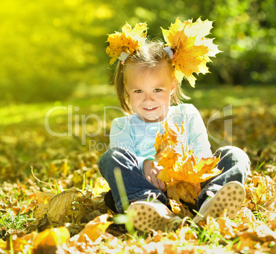 Portrait of a little girl in autumn park