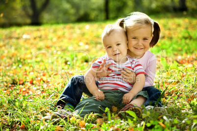 Children are playing in autumn park