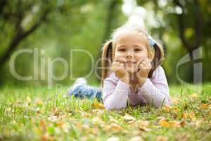 Portrait of a little girl in autumn park