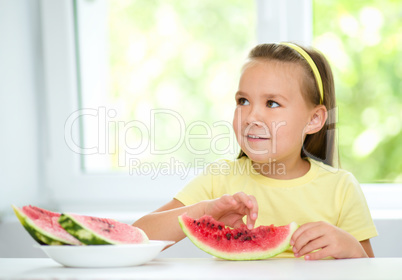 Little girl is eating watermelon