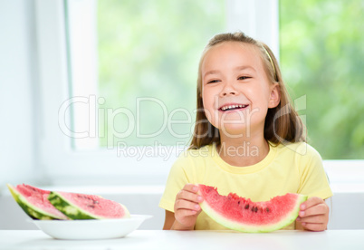 Cute little girl is eating watermelon