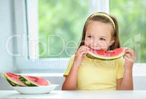 Cute little girl is eating watermelon