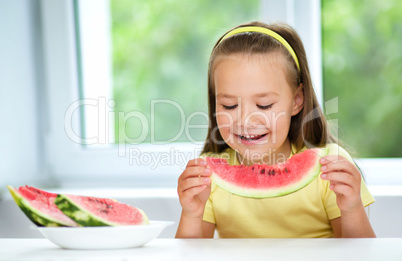 Cute little girl is eating watermelon