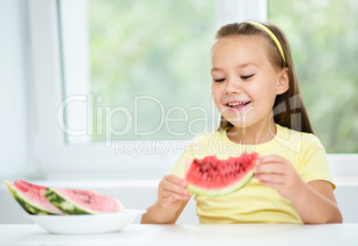 Cute little girl is eating watermelon