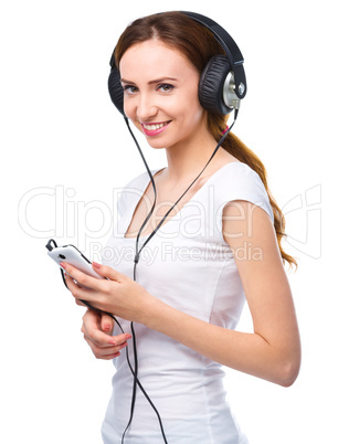 Young woman enjoying music using headphones