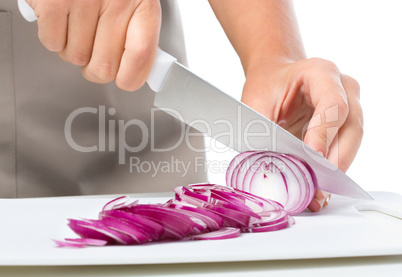 Cook is chopping onion