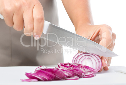 Cook is chopping onion