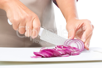 Cook is chopping onion