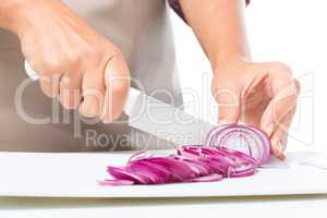 Cook is chopping onion