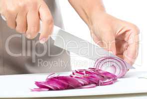 Cook is chopping onion