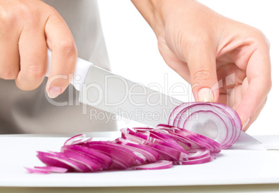 Cook is chopping onion