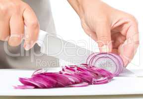 Cook is chopping onion