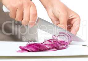 Cook is chopping onion