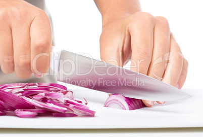 Cook is chopping onion