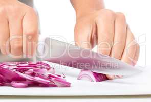 Cook is chopping onion