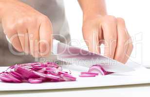 Cook is chopping onion