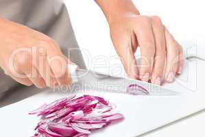 Cook is chopping onion