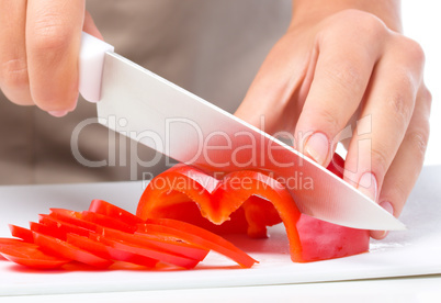 Cook is chopping bell pepper