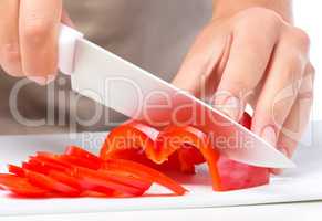 Cook is chopping bell pepper