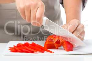 Cook is chopping bell pepper