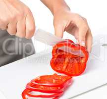 Cook is chopping bell pepper