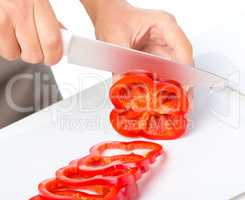 Cook is chopping bell pepper