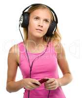 Teen girl enjoying music using headphones