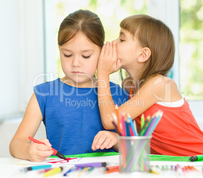 Little girls are drawing using felt- tip pens