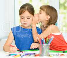 Little girls are drawing using felt- tip pens