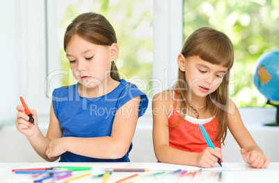 Little girls are drawing using felt- tip pens