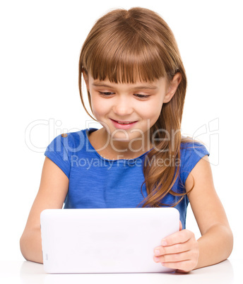 Young cheerful girl is using tablet