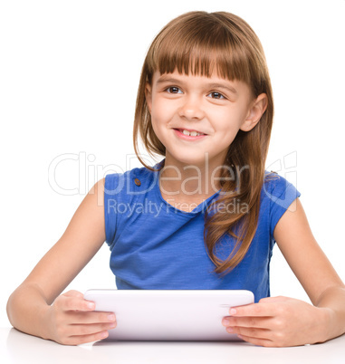 Young cheerful girl is using tablet